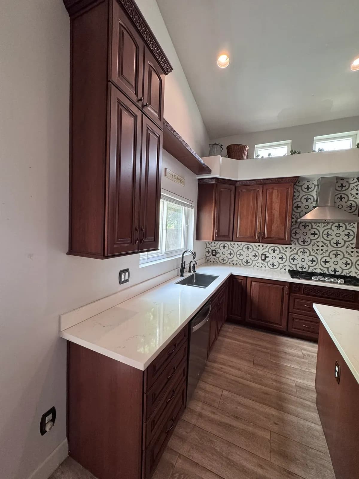 An East Valley kitchen with dated dark cherry-wood cabinets, before Valley Painting Pros refinished it.