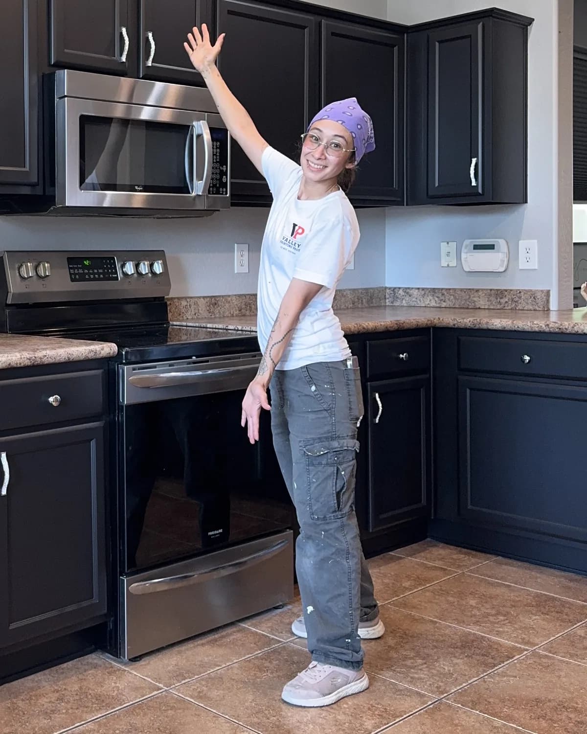Gereimy, Valley Painting Pros' project manager, standing in a finished East Valley kitchen with refinished espresso cabinets.