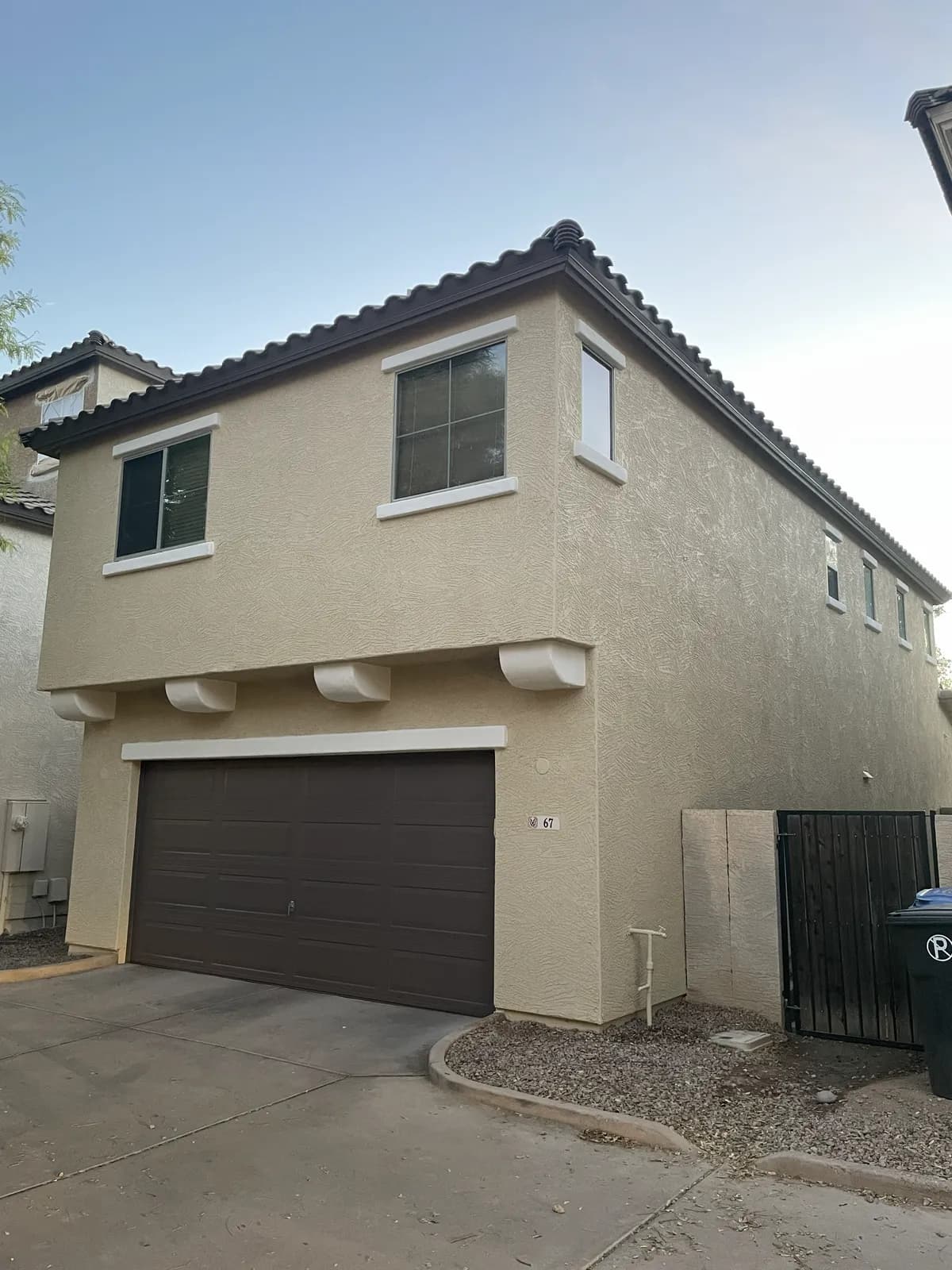 Crisp painted trim and a freshly coated garage on an East Valley home by Valley Painting Pros.