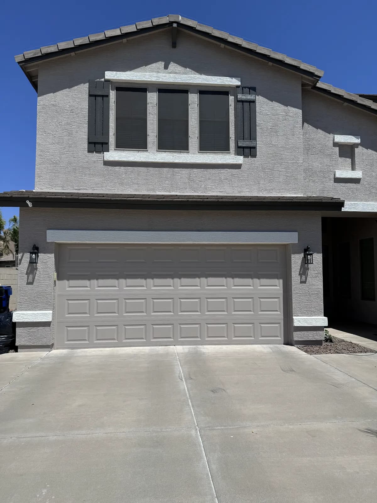 The freshly painted rear exterior and covered patio of an East Valley home by Valley Painting Pros.