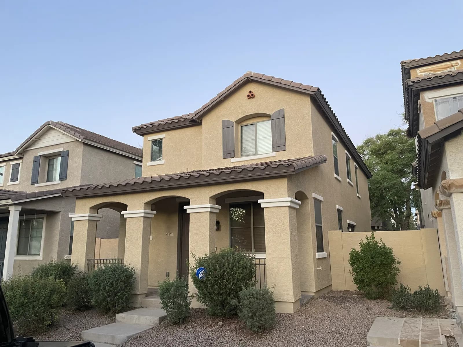 A two-story home with a warm exterior color, repainted by Valley Painting Pros.