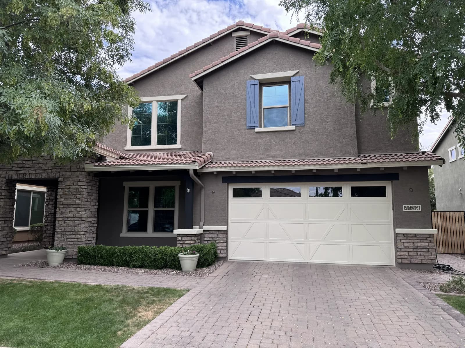A two-story East Valley home repainted by Valley Painting Pros — walls, trim, shutters and garage door all finished to match.