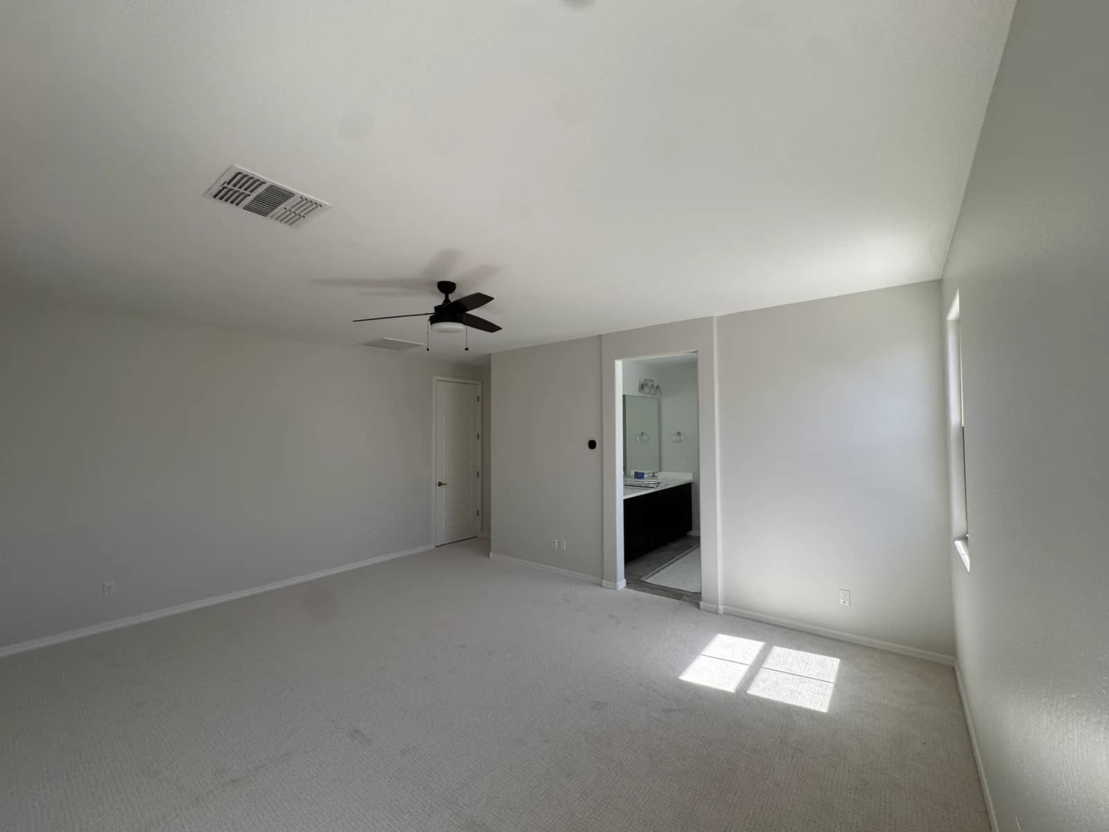 A freshly painted master bedroom opening to its ensuite bathroom — interior work by Valley Painting Pros.